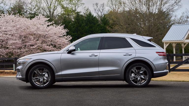 2024 Genesis Electrified GV70 driving on the road.